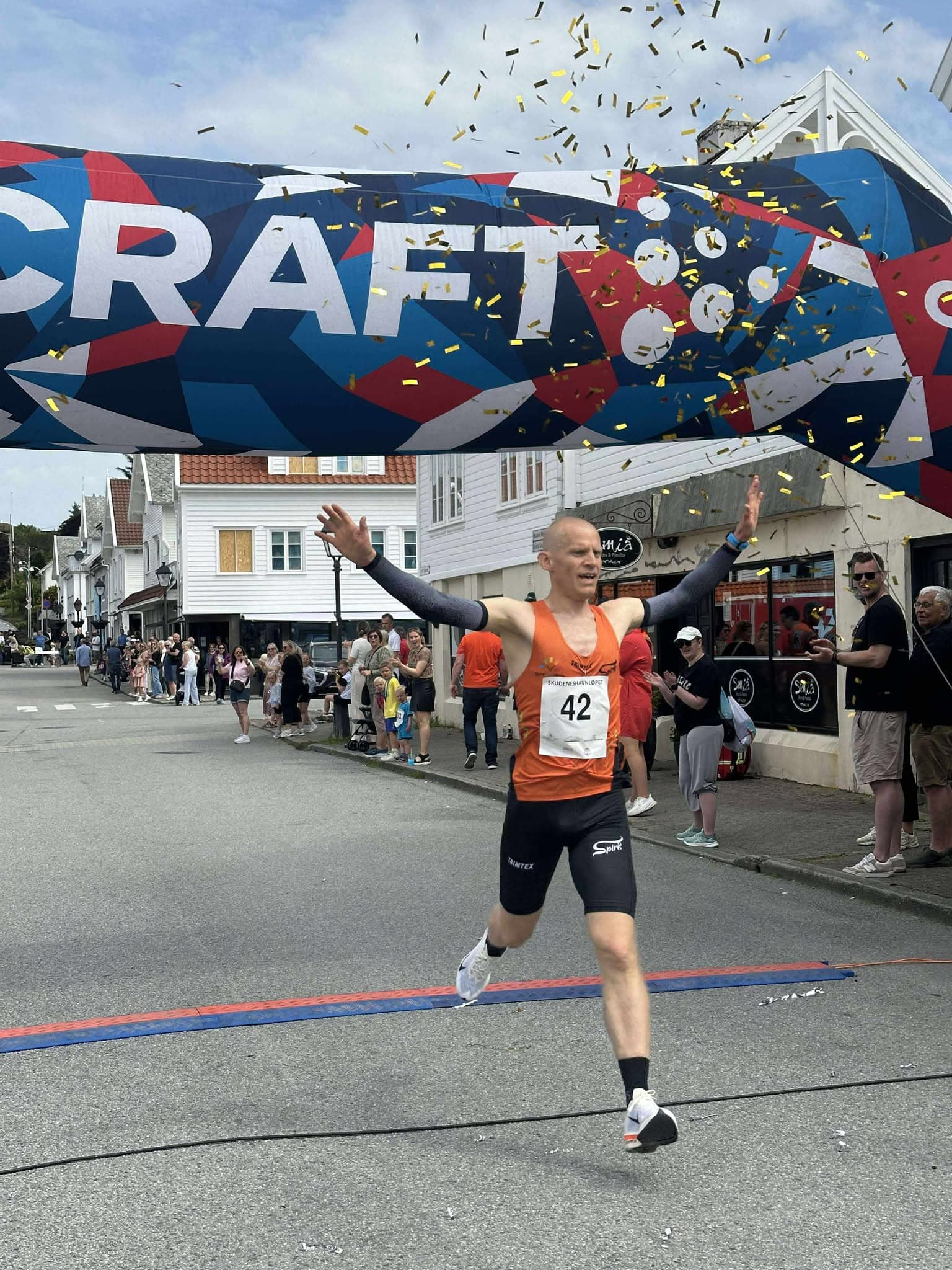 Vinner krysser mållinjen med konfetti